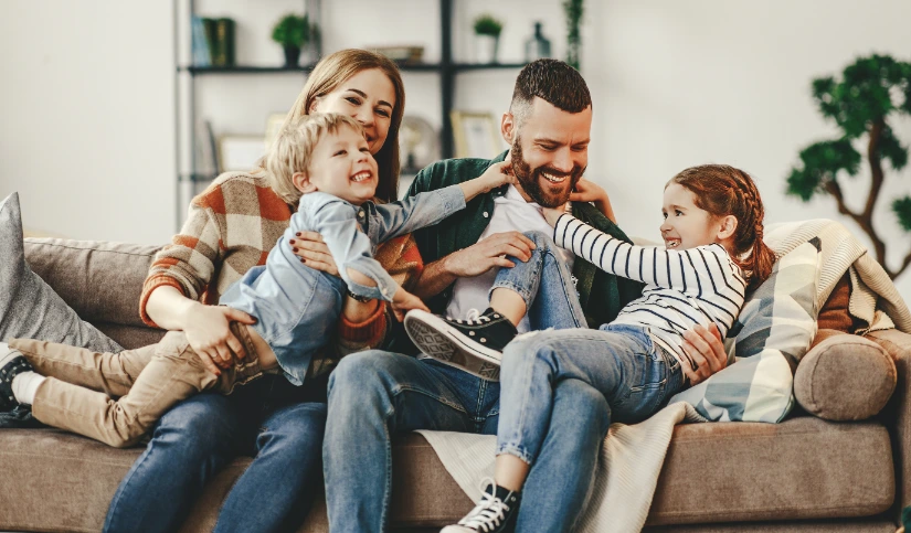 Family sitting on couch playing