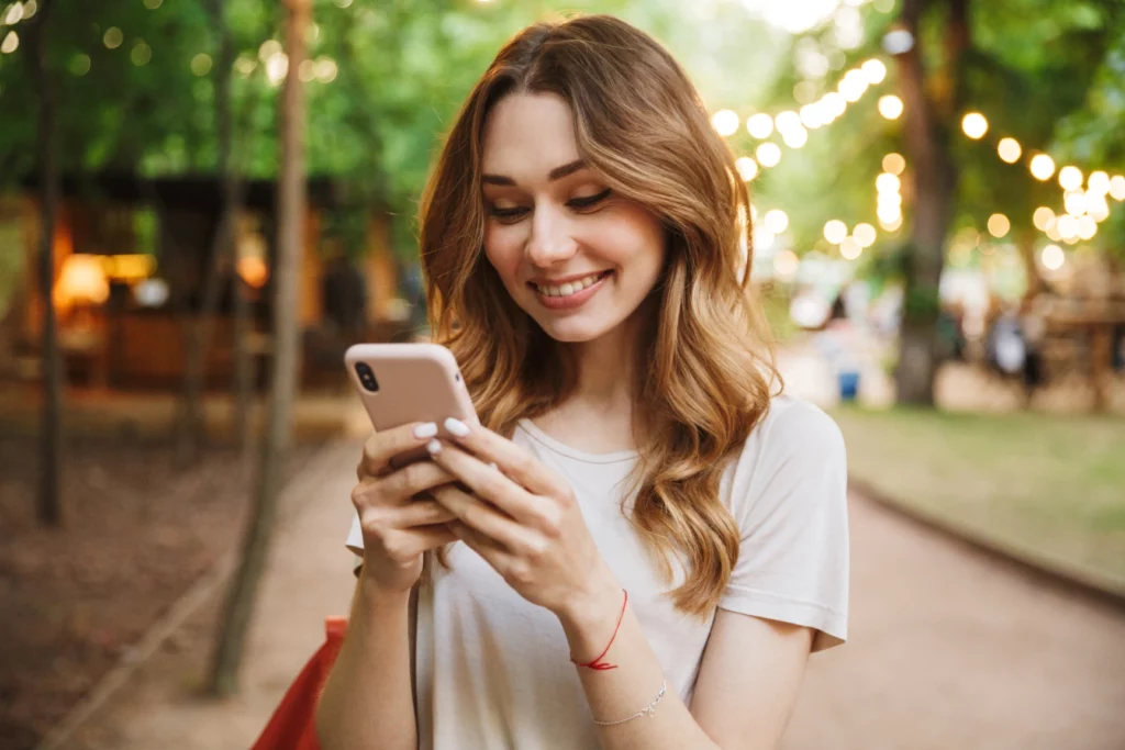 Woman happy on phone outside