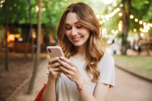 Woman happy on phone outside